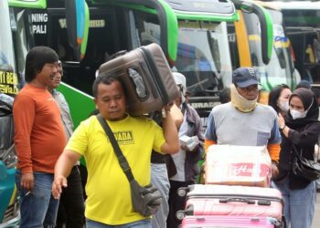 Pemudik membawa barangnya menuju ruang tunggu keberangkatan bus di Terminal Kalideres, Jakarta Barat, Kamis (28/4/2022).