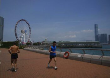 People Run At A Waterfront In Hong Kong, Thursday, May 5, 2022.