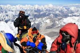 Pendaki berfoto saat mencapai puncak Gunung Everest. Pemerintah Nepal mengeluarkan aturan memperketat izin mendaki ke puncak Everest setelah muncul korban.