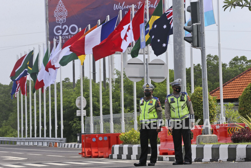 Polisi berjaga saat bendera negara G20 berkibar di jalan menuju tempat KTT G20 di Nusa Dua, Bali, (ilustrasi).