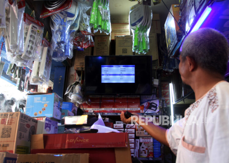 Pedagang menjelaskan pemakaian perangkat set top box TV Digital di Pasar Raya Padang, Sumatera Barat, Jumat (4/11/2022). Penjualan