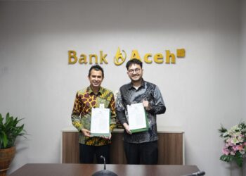 Direktur Dana dan Jasa Bank Aceh Syariah, Hendra Supardi saat bersama salah satu perwakilan PT PosSaku Mitra Usaha dalam upaya memperkuat ekosistem digital UMKM melalui integrasi layanan keuangan dan teknologi Point of Sale (POS). FOTO/Dok. BAS untuk HAI.